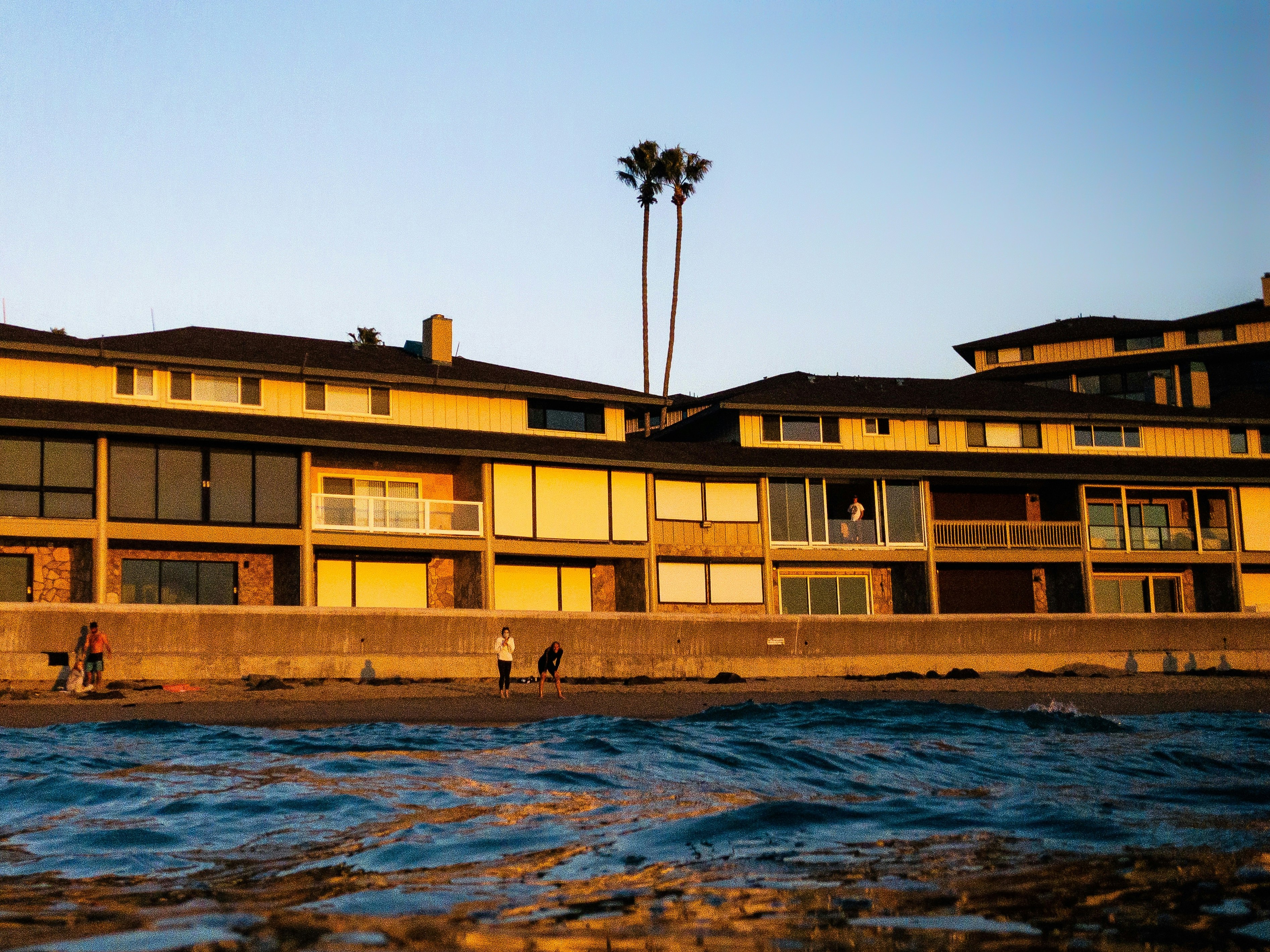 brown concrete building near body of water during daytime